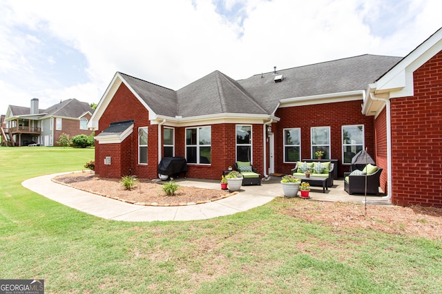 1365 Ivy Plantation, Monroe, GA 30656 - back of house featuring a patio, brick siding, a lawn, a shingled roof, and an outdoor hangout area