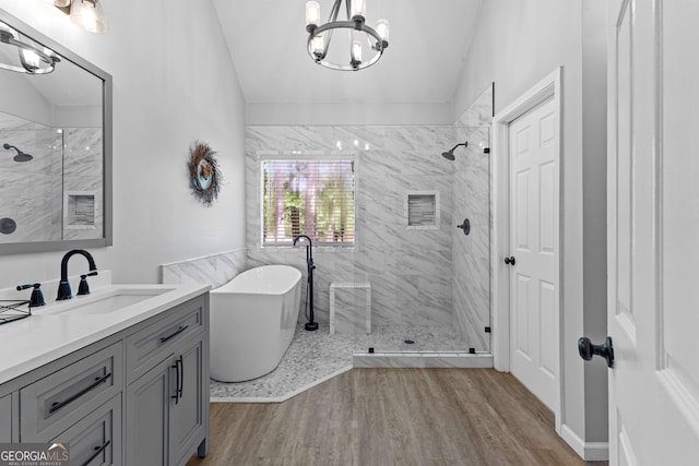 226 Le Paradis Blvd, Sharpsburg, GA 30277 - bathroom with a stall shower, a chandelier, a freestanding bath, vanity, and wood finished floors