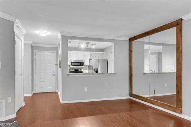 3655 Habersham Rd NE Unit 244B, Atlanta, GA 30305 - kitchen with stainless steel appliances, crown molding, wood finished floors, white cabinets, and baseboards