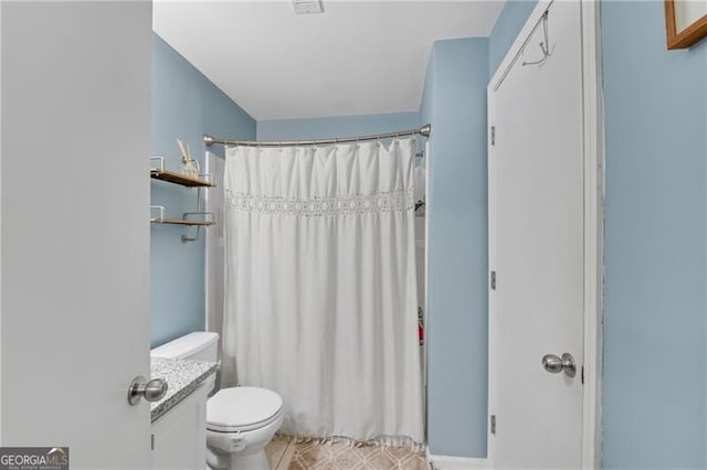 full bathroom featuring toilet, a shower with curtain, and tile patterned floors