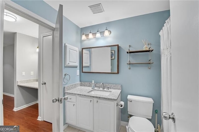 3655 Habersham Rd NE Unit 244B, Atlanta, GA 30305 - bathroom featuring vanity, wood finished floors, toilet, and baseboards
