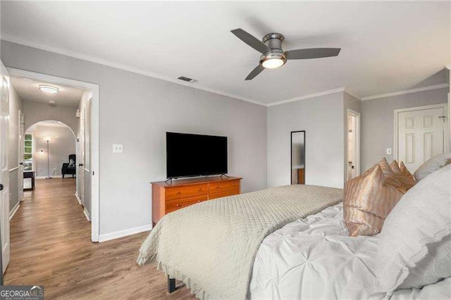 1140 Moorestown Cir, Decatur, GA 30033 - bedroom featuring arched walkways, light wood-style flooring, baseboards, ornamental molding, and a ceiling fan