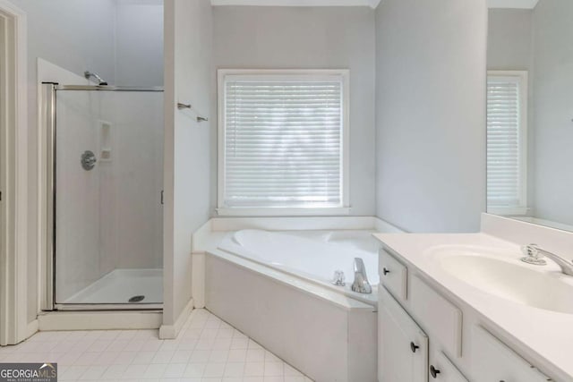 bathroom with a shower stall, vanity, a bath, and tile patterned flooring