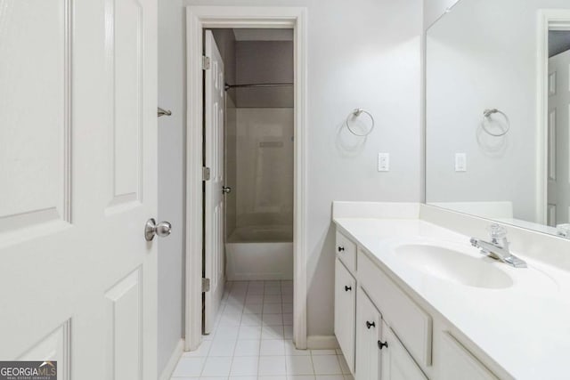 bathroom with vanity, tile patterned floors, tub / shower combination, and baseboards