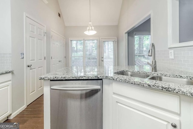 kitchen with dishwasher, a sink, vaulted ceiling, dark wood-style flooring, and backsplash
