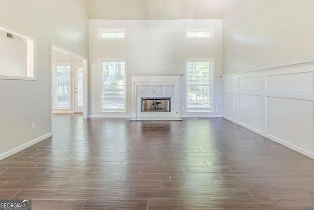 5335 Lexington View Pl, Sugar Hill, GA 30518 - unfurnished living room with dark wood-style floors, a high ceiling, and a high end fireplace