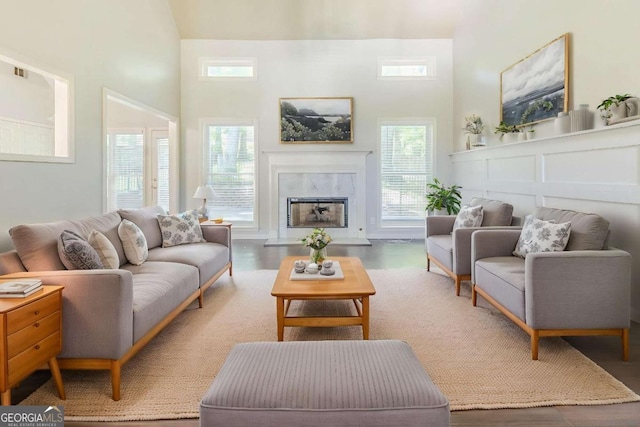 5335 Lexington View Pl, Sugar Hill, GA 30518 - living area featuring a fireplace, a high ceiling, and wood finished floors