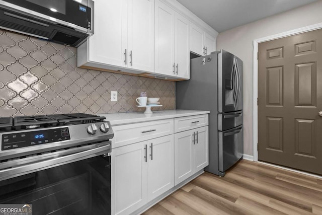 222 Harmony Ct, Alpharetta, GA 30004 - kitchen featuring appliances with stainless steel finishes, light countertops, white cabinets, light wood-style floors, and backsplash