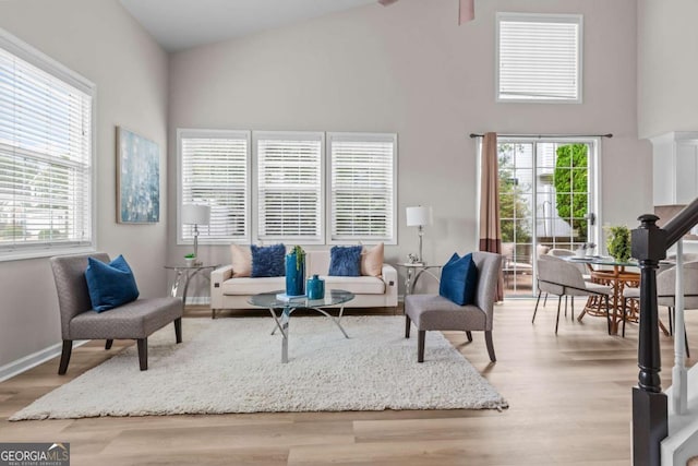 222 Harmony Ct, Alpharetta, GA 30004 - living area with high vaulted ceiling, baseboards, wood finished floors, and plenty of natural light