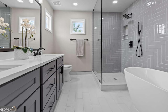 222 Harmony Ct, Alpharetta, GA 30004 - bathroom with double vanity, a tile shower, a freestanding tub, toilet, and recessed lighting
