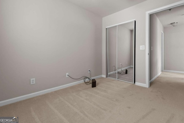 222 Harmony Ct, Alpharetta, GA 30004 - unfurnished bedroom featuring carpet flooring, a closet, and baseboards