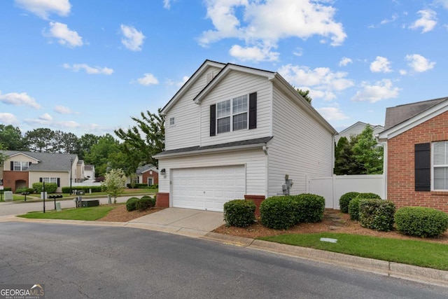 222 Harmony Ct, Alpharetta, GA 30004 - view of front of house featuring an attached garage, driveway, fence, and brick siding