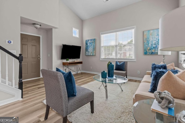 222 Harmony Ct, Alpharetta, GA 30004 - living area featuring wood finished floors, stairway, baseboards, and high vaulted ceiling