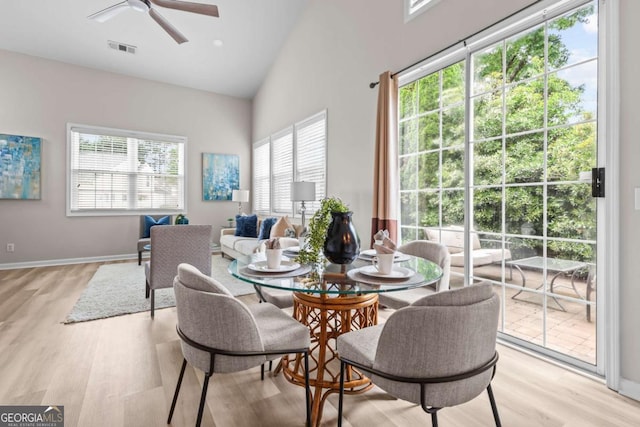222 Harmony Ct, Alpharetta, GA 30004 - dining area featuring light wood finished floors, a ceiling fan, high vaulted ceiling, and baseboards