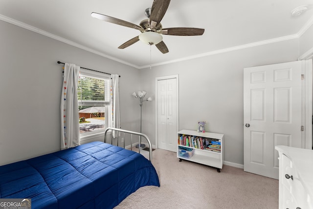 bedroom with light colored carpet, ornamental molding, ceiling fan, a closet, and baseboards