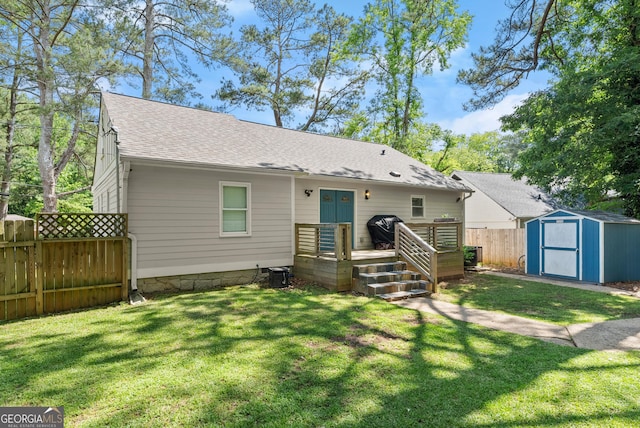 view of front of house with a shed, roof with shingles, a wooden deck, an outbuilding, and central air condition unit