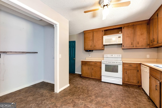 1405 Lumpkin County Pkwy, Dahlonega, GA 30533 - kitchen featuring white appliances, brown cabinets, ceiling fan, light countertops, and dark floors