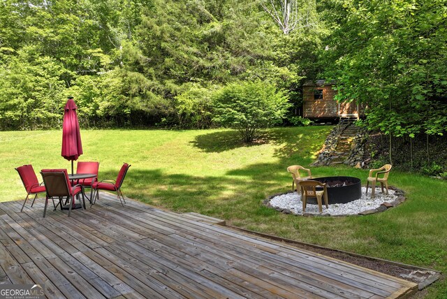 1405 Lumpkin County Pkwy, Dahlonega, GA 30533 - wooden deck featuring an outdoor fire pit, a yard, an outdoor structure, outdoor dining area, and a storage shed