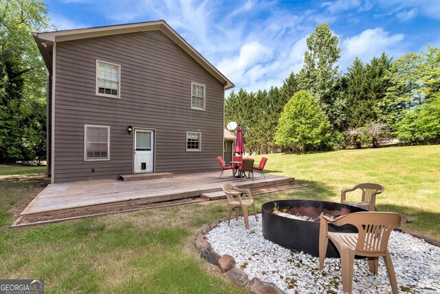 1405 Lumpkin County Pkwy, Dahlonega, GA 30533 - back of house with an outdoor fire pit, a wooden deck, and a lawn
