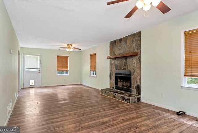 1405 Lumpkin County Pkwy, Dahlonega, GA 30533 - unfurnished living room featuring a ceiling fan, wood finished floors, a fireplace, and baseboards