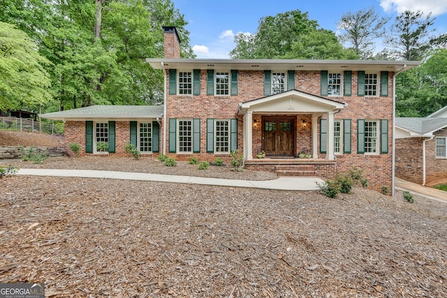 2592 River Oak Dr, Decatur, GA 30033 - georgian-style home featuring a chimney and brick siding