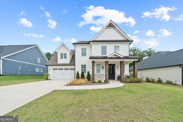 craftsman-style house with board and batten siding, concrete driveway, and a front yard