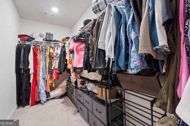 walk in closet with carpet