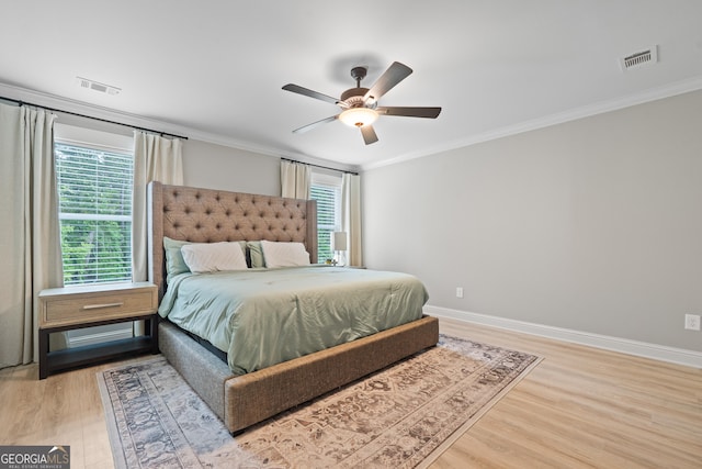 bedroom with ornamental molding, wood finished floors, baseboards, and a ceiling fan