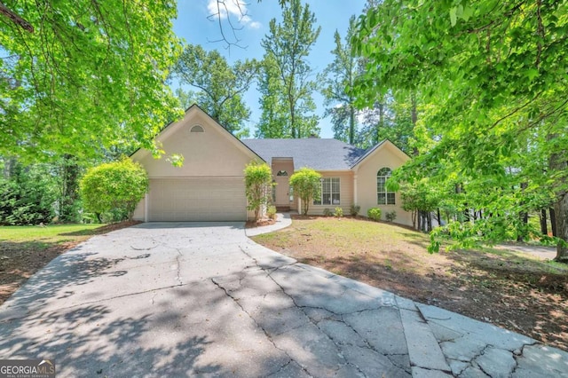 616 Lone Oak Ct, Lithonia, GA 30058 - view of front of home with a garage, driveway, and stucco siding