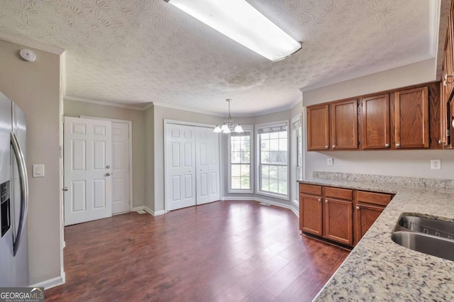 616 Lone Oak Ct, Lithonia, GA 30058 - kitchen featuring stainless steel refrigerator with ice dispenser, a chandelier, dark wood-style floors, brown cabinets, and a textured ceiling