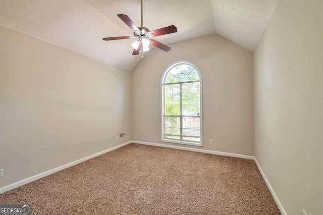 616 Lone Oak Ct, Lithonia, GA 30058 - spare room with carpet flooring, vaulted ceiling, baseboards, ceiling fan, and a textured ceiling