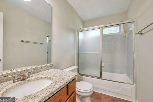 616 Lone Oak Ct, Lithonia, GA 30058 - bathroom featuring toilet, wood finished floors, vanity, and enclosed tub / shower combo