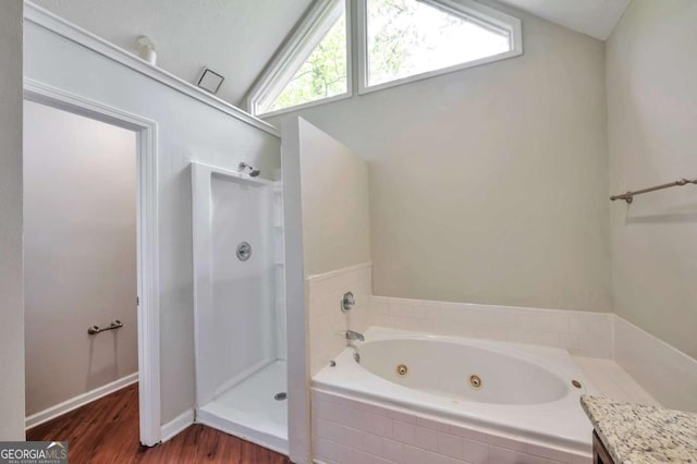 616 Lone Oak Ct, Lithonia, GA 30058 - full bath featuring a stall shower, wood finished floors, a jetted tub, lofted ceiling, and plenty of natural light
