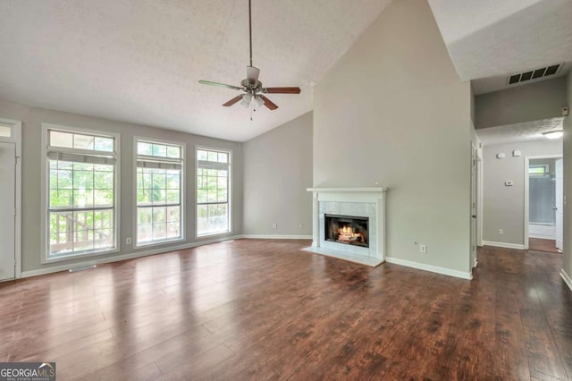 616 Lone Oak Ct, Lithonia, GA 30058 - unfurnished living room with a ceiling fan, plenty of natural light, a fireplace with flush hearth, high vaulted ceiling, and wood finished floors