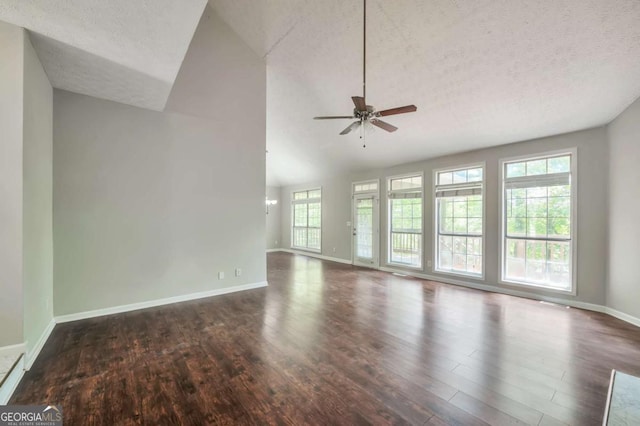 616 Lone Oak Ct, Lithonia, GA 30058 - unfurnished living room featuring wood finished floors, a textured ceiling, vaulted ceiling, baseboards, and ceiling fan