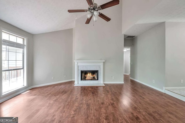 616 Lone Oak Ct, Lithonia, GA 30058 - unfurnished living room with wood finished floors, a high end fireplace, ceiling fan, baseboards, and a textured ceiling