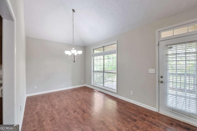 616 Lone Oak Ct, Lithonia, GA 30058 - unfurnished dining area with a chandelier, lofted ceiling, wood finished floors, and baseboards