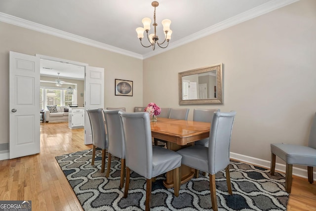 1201 Bridle Path, Marietta, GA 30068 - dining space featuring a chandelier, crown molding, light wood-style flooring, and baseboards