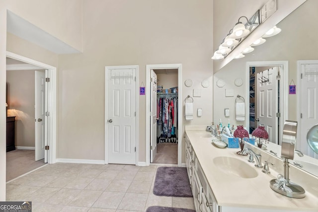 1201 Bridle Path, Marietta, GA 30068 - full bathroom with a high ceiling, tile patterned flooring, double vanity, baseboards, and a walk in closet