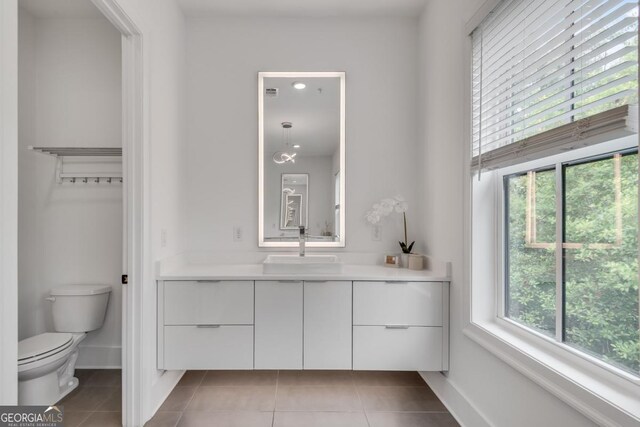 574 Boulevard Pl NE Unit 4, Atlanta, GA 30308 - bathroom with tile patterned flooring, toilet, vanity, and baseboards