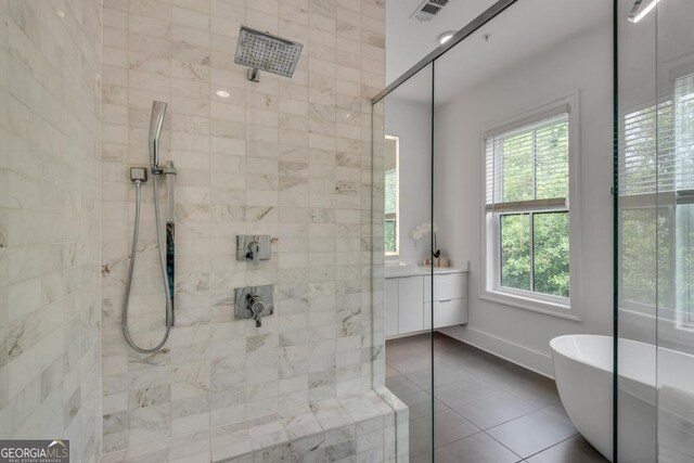 574 Boulevard Pl NE Unit 4, Atlanta, GA 30308 - full bathroom featuring tile patterned floors, vanity, a tile shower, a soaking tub, and baseboards