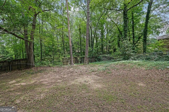 361 Gordon Valley Ln SW, Mableton, GA 30126 - view of yard with fence and a wooded view