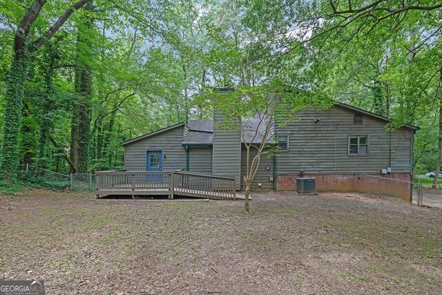 361 Gordon Valley Ln SW, Mableton, GA 30126 - back of house featuring central air condition unit, a deck, fence, and a chimney