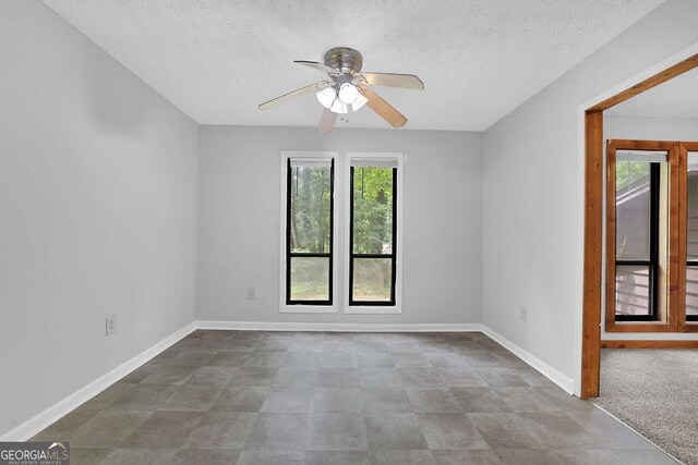 361 Gordon Valley Ln SW, Mableton, GA 30126 - empty room featuring a ceiling fan, a textured ceiling, and baseboards