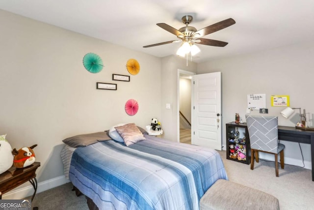 carpeted bedroom with a ceiling fan and baseboards