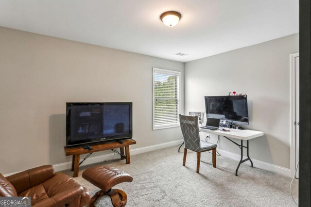 carpeted home office with baseboards