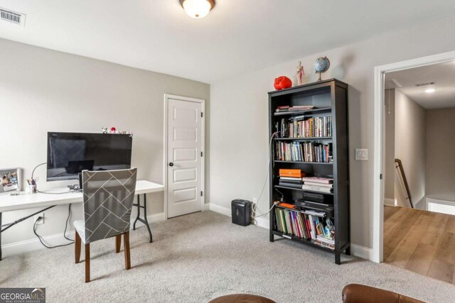 carpeted home office with baseboards