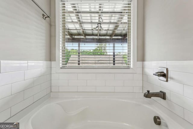 bathroom with a bath and healthy amount of natural light