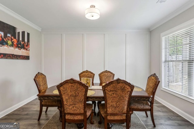 dining space featuring ornamental molding, baseboards, and dark wood-style floors