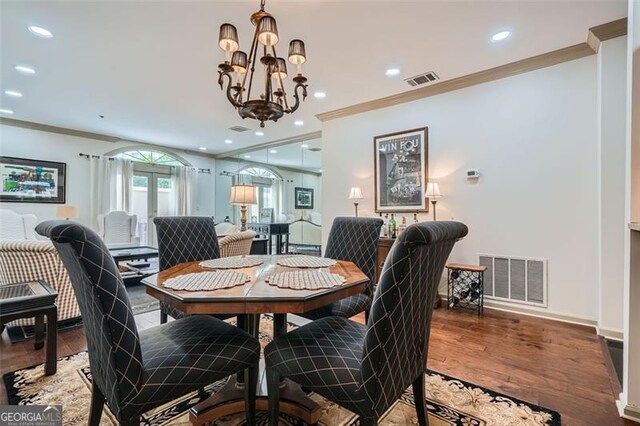 2499 Peachtree Rd Unit 108, Atlanta, GA 30305 - dining area with crown molding, a chandelier, wood finished floors, recessed lighting, and baseboards